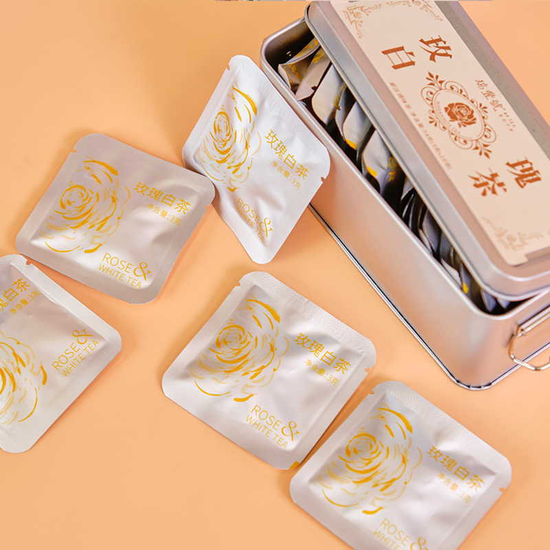 White rose tea mini cakes in metal gift tin