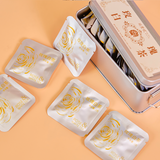 White rose tea mini cakes in metal gift tin
